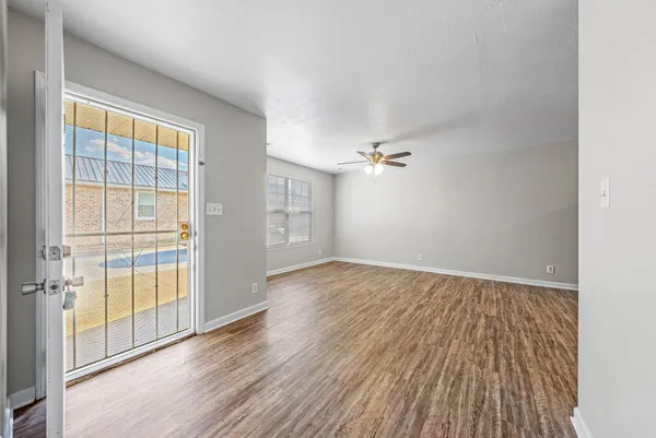 wooden floor in an empty room with a window