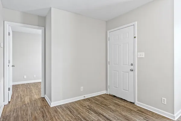 a view of an empty room and wooden floor