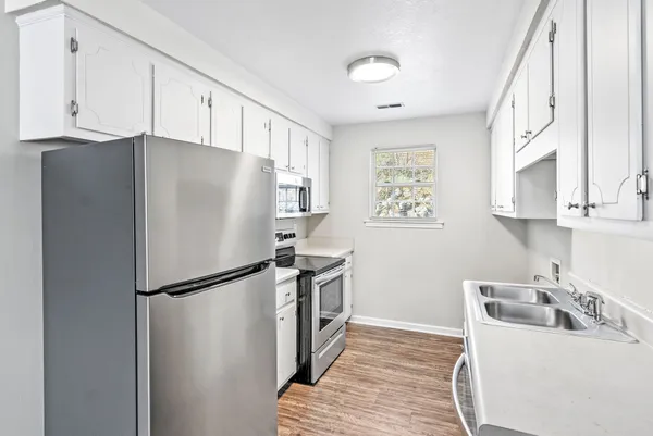 a kitchen with stainless steel appliances a refrigerator and a sink