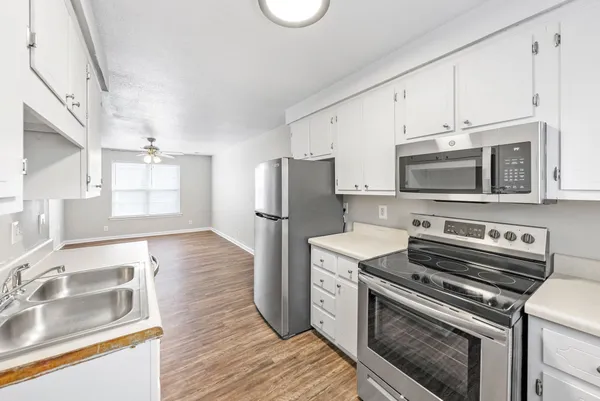 a kitchen with a stove a sink and a microwave