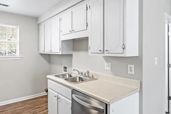 a kitchen with stainless steel appliances white cabinets and a sink