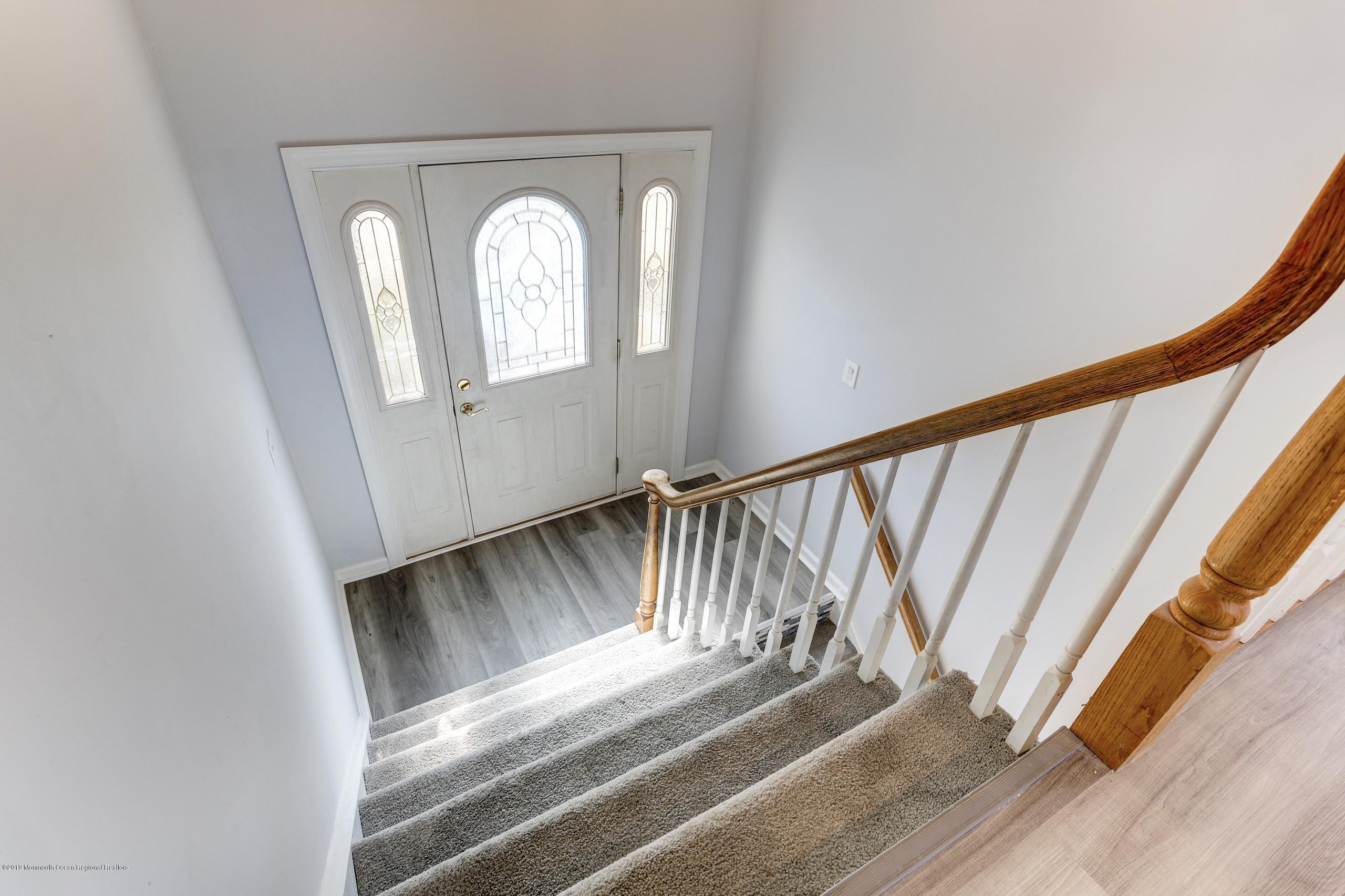 32 Hedgewood Road Howell, NJ 07731 - Photo 15 of 30 a view of staircase with railing and a floor to ceiling window