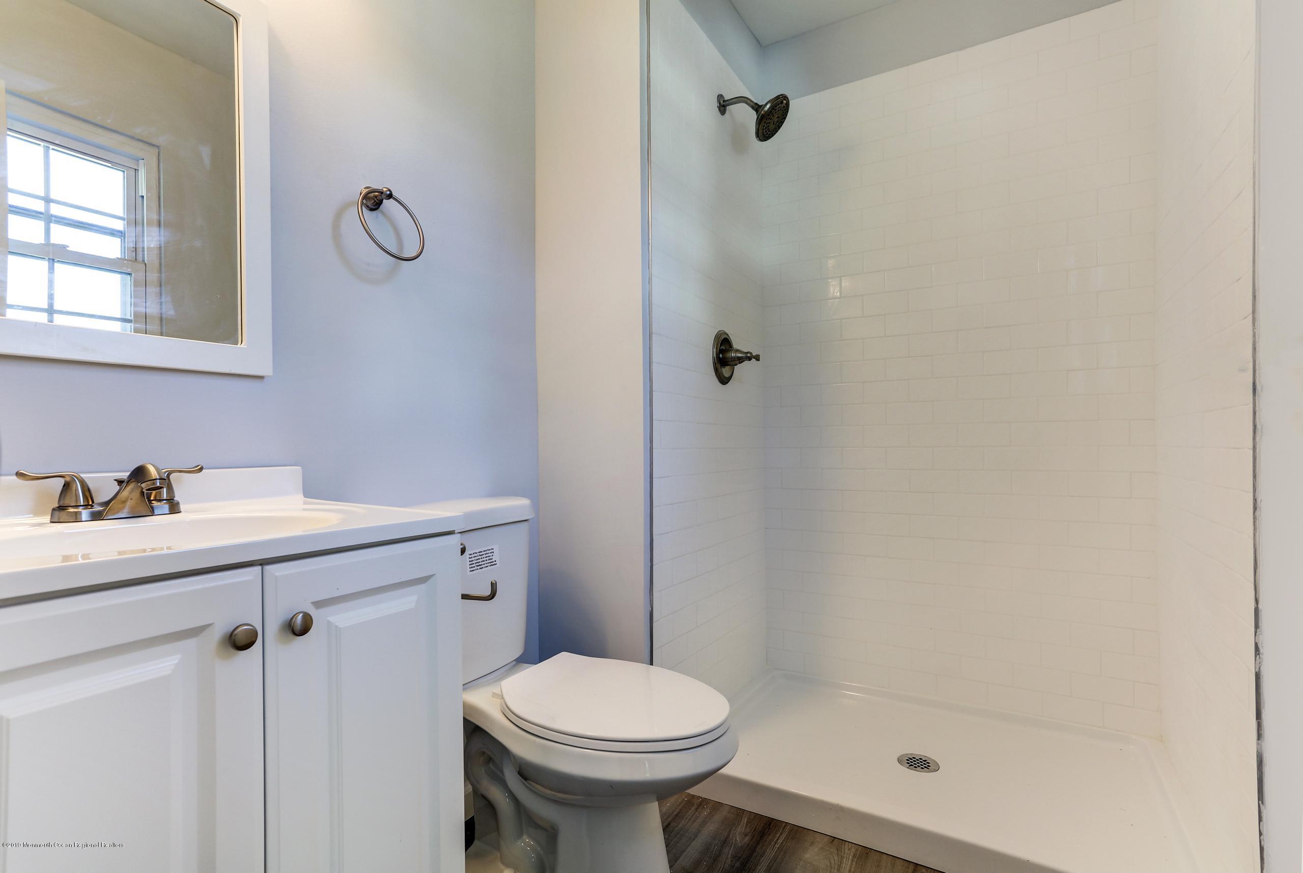 32 Hedgewood Road Howell, NJ 07731 - Photo 20 of 30 a bathroom with a sink a toilet and shower