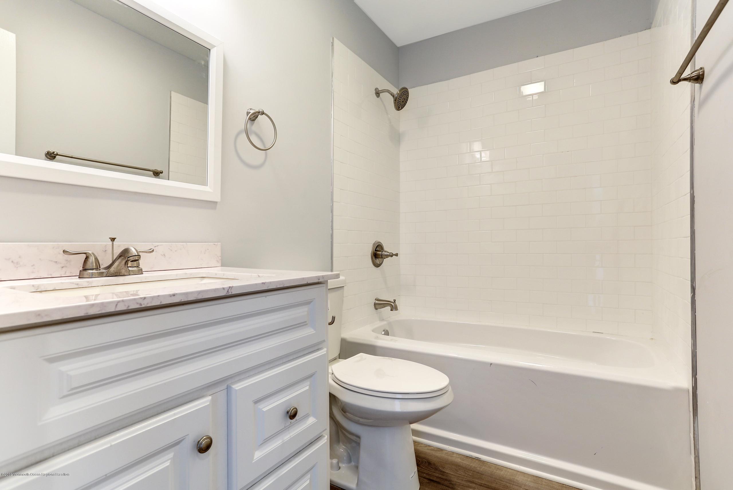 32 Hedgewood Road Howell, NJ 07731 - Photo 21 of 30 a bathroom with a sink a toilet and shower