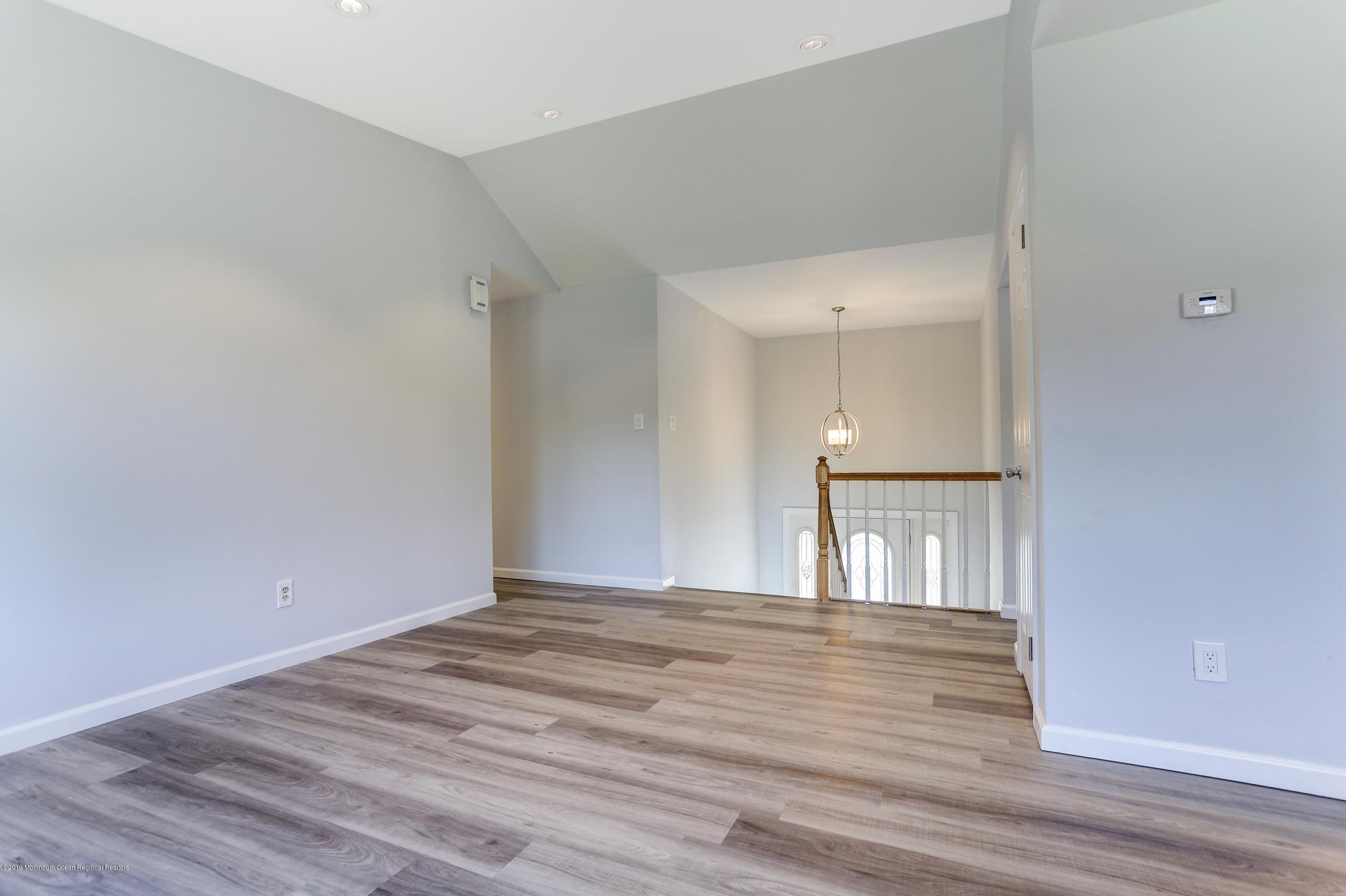 32 Hedgewood Road Howell, NJ 07731 - Photo 5 of 30 a view of empty room with wooden floor and fan