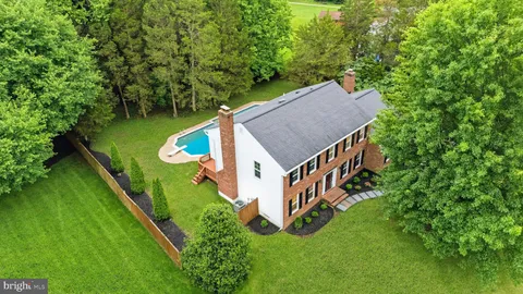 an aerial view of a house with pool