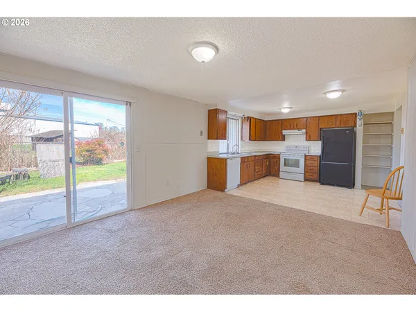 a kitchen with a sink a stove and cabinets