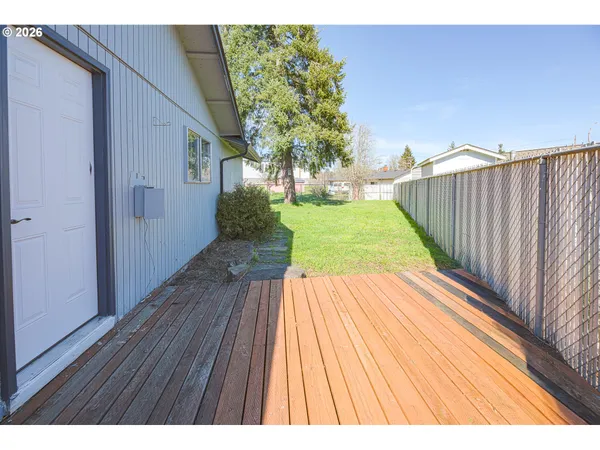 a view of a backyard with large trees