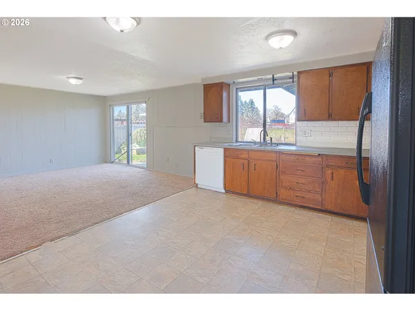 a kitchen with stainless steel appliances granite countertop a refrigerator and a sink