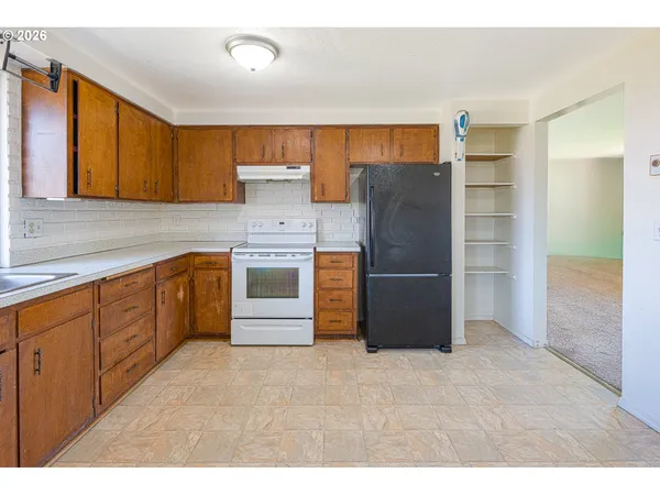 a kitchen with granite countertop a sink stainless steel appliances and cabinets