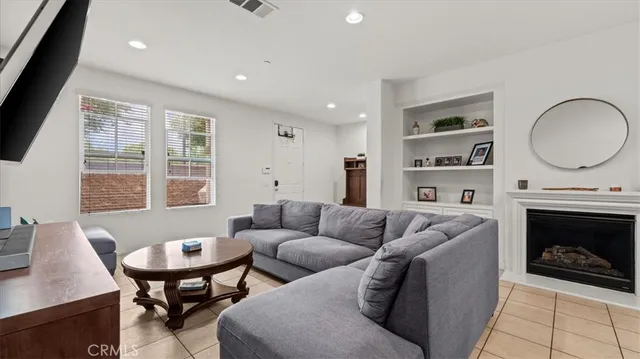 a living room with furniture a fireplace and a table
