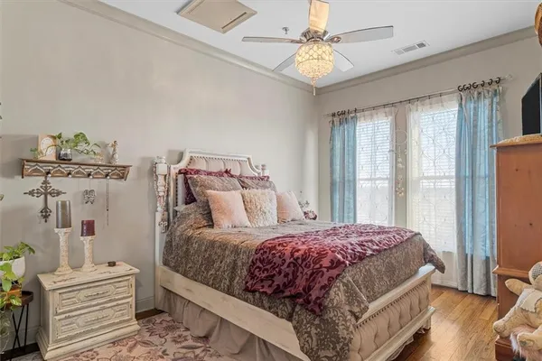 a bedroom with a bed wooden floor and window
