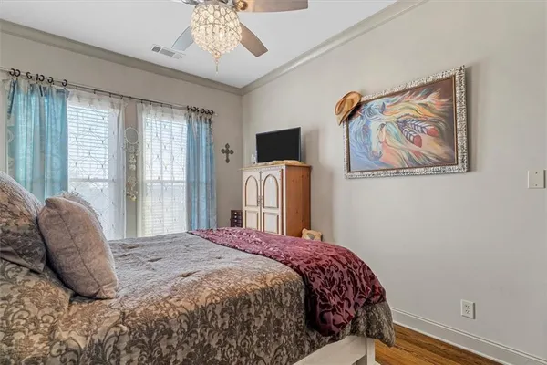 a bedroom with a bed and a painting on the wall