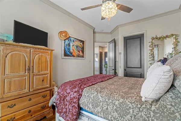 a bedroom with a bed and a chandelier