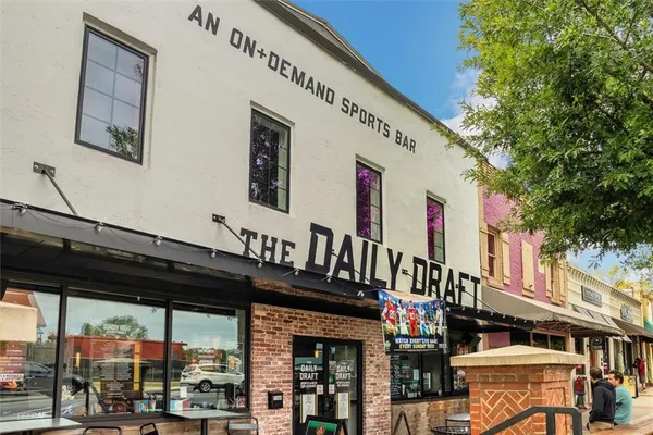 a front view of multi story residential apartment building with retail shop and retail shop