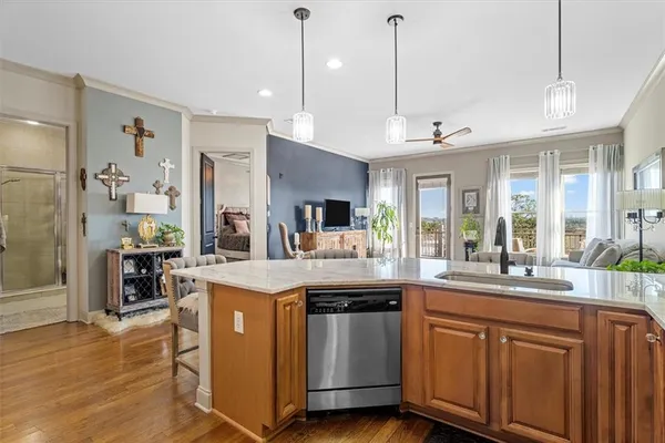 a kitchen with stainless steel appliances granite countertop a sink a stove and a large window