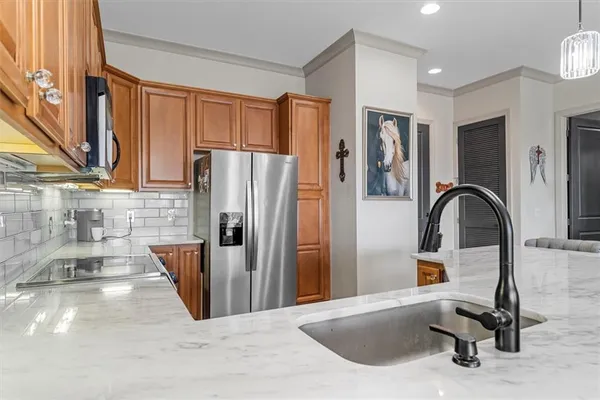 a kitchen with a refrigerator a sink and cabinets