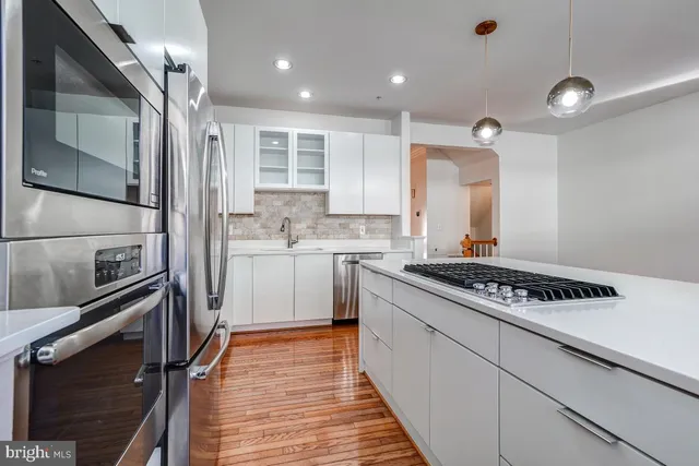 a kitchen with a refrigerator stove and microwave