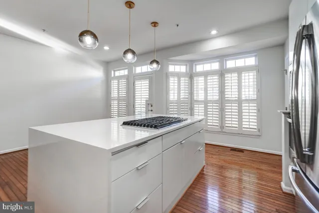 a kitchen with stainless steel appliances granite countertop a sink and a white cabinets