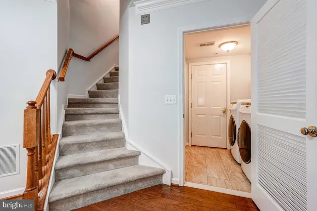 a view of an entryway with wooden floor and door