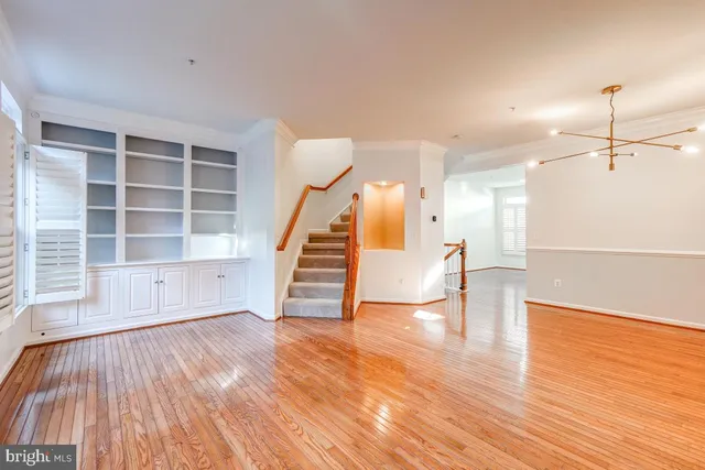 a view of a room with wooden floor and white walls