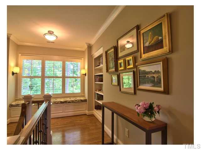 7916 Longleaf Branch Court Raleigh, NC 27612 - Photo 16 of 25 Welcome to the 2nd Floor, gracious hideaway ! Built-In Bookshelves and custom Window Seat w/a view overlooking the private backyard, a lovely escape. Hardwood floors everywhere in this house, only the bedrooms & bonus rooms are carpeted.