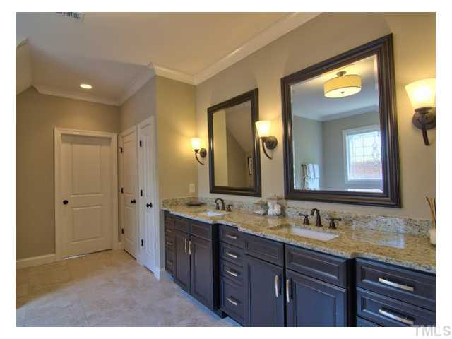 7916 Longleaf Branch Court Raleigh, NC 27612 - Photo 18 of 25 Beautiful cabinetry, granite and lighting in this master spa, lovely inset square porcelain sinks, no detail spared. Straight ahead is a door that leads to the walk-in closet/dressing area measuring 13.1x13.8, custom shelving was also added.