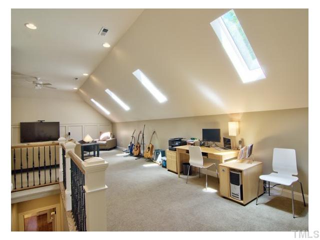 7916 Longleaf Branch Court Raleigh, NC 27612 - Photo 24 of 25 No detail was spared for custom finished Theater/Media room space with skylights, iron balusters and panelling that matches the rest of the house. Current owner used the 'loft portion' of this 3rd floor space as an office/music area. 3rd Zone HVAC added