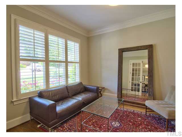 Formal first floor study/living room/home office, faces the front yard/cul de sac. Abundant natural light, desk is to the right and not in picture.Adjacent to bodacious foyer area, view of dining room across foyer in mirror reflection
