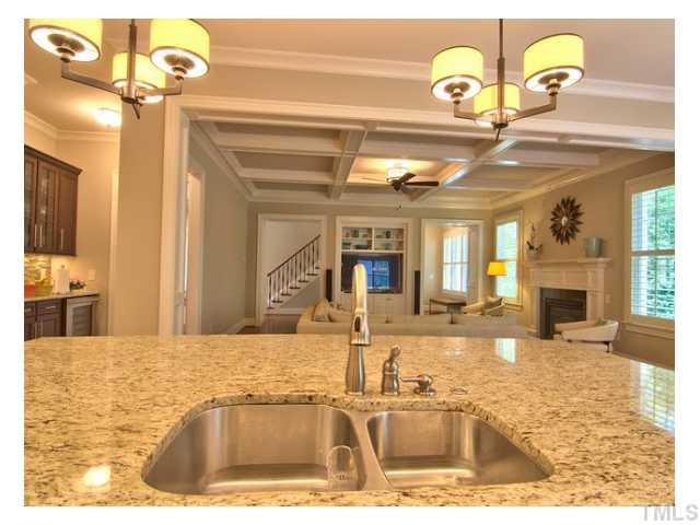 7916 Longleaf Branch Court Raleigh, NC 27612 - Photo 10 of 25 The Cook's View of the Great Room, Wine Bar to the left, (Bosch Dishwasher is to right of sinks below). Notice coffered ceiling detail and gas fireplace in the Great Room. Yes! You cook here!