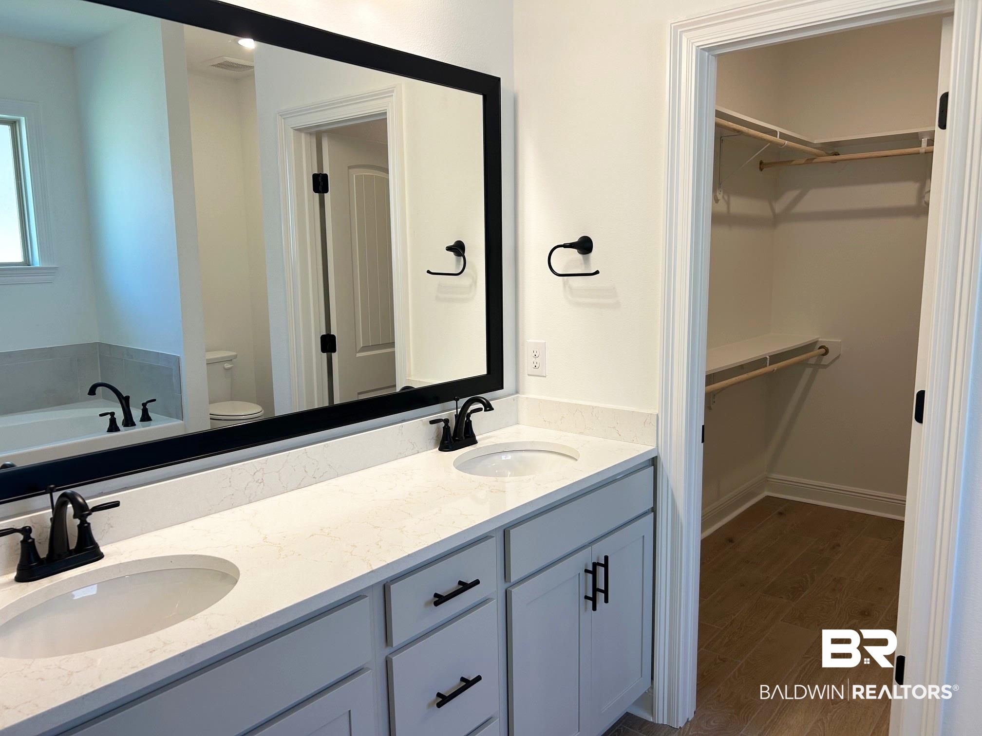 812 Sumter Loop Foley, AL 36535 - Photo 7 of 17 Bathroom featuring hardwood / wood-style flooring, vanity, toilet, and a tub