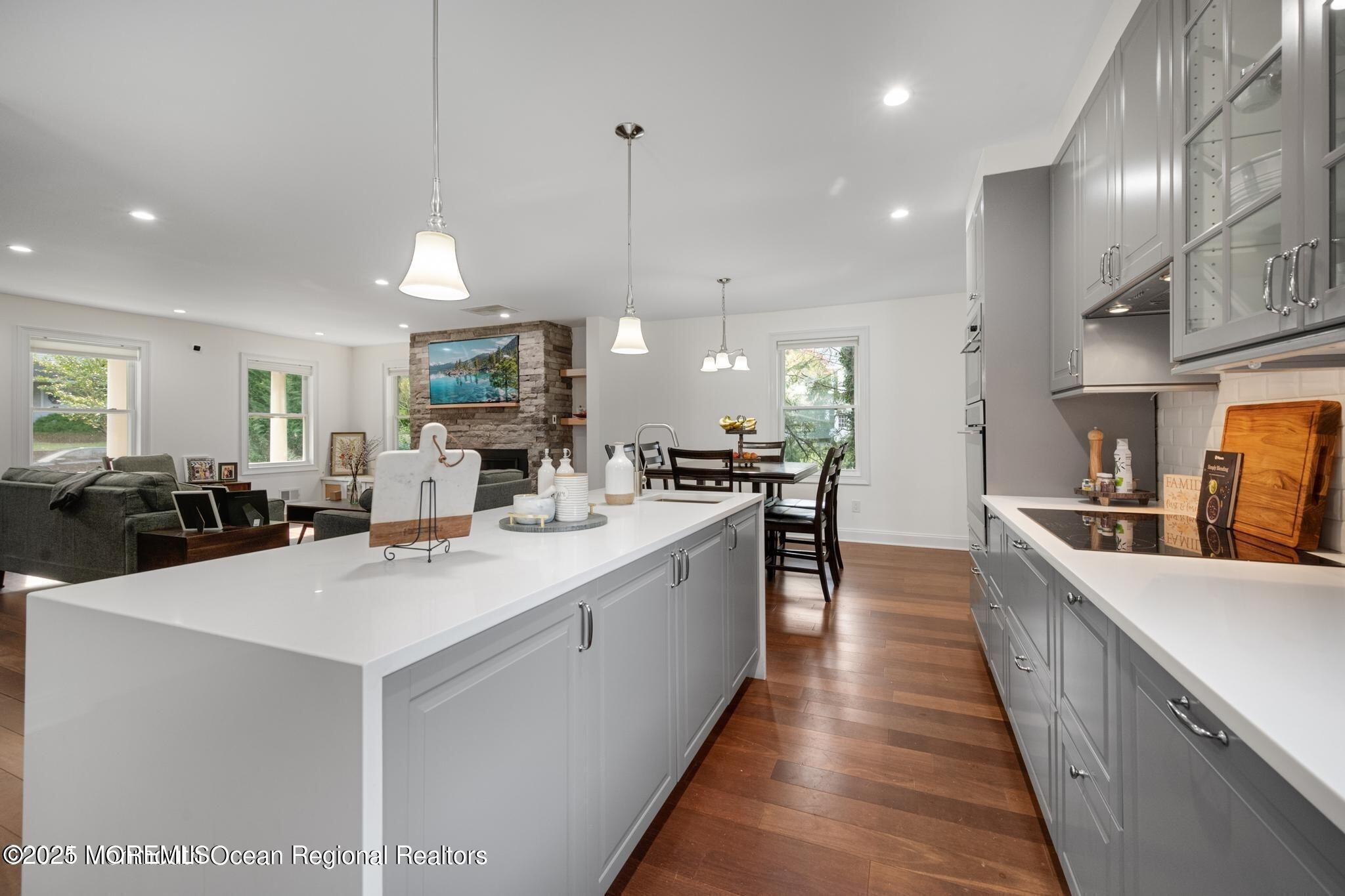 300 Monmouth Road West Long Branch, NJ 07764 - Photo 9 of 10 a large kitchen with kitchen island a sink counter space and a view of living room