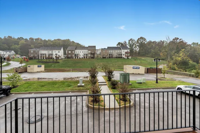 an empty room with windows and ceiling fan
