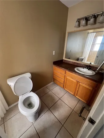 a bathroom with a toilet and a mirror