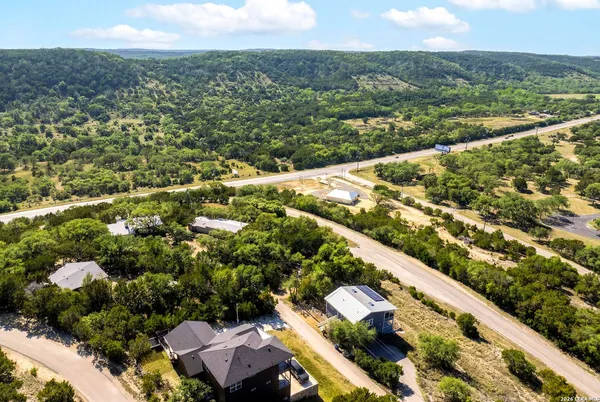 an aerial view of residential houses with outdoor space