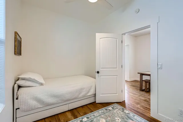 a bedroom with a bed and hallway