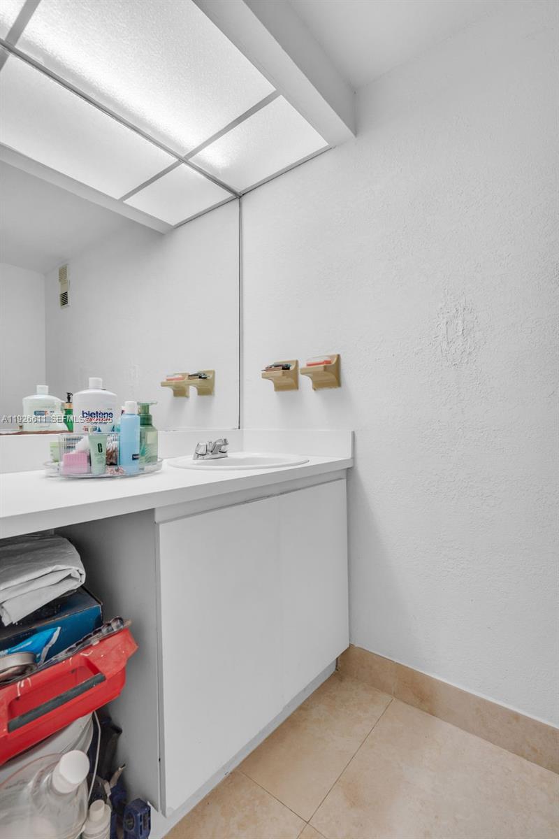 1900 West 68th Street, Unit F302 Hialeah, FL 33014 - Photo 11 of 34 a room with a sink and a mirror