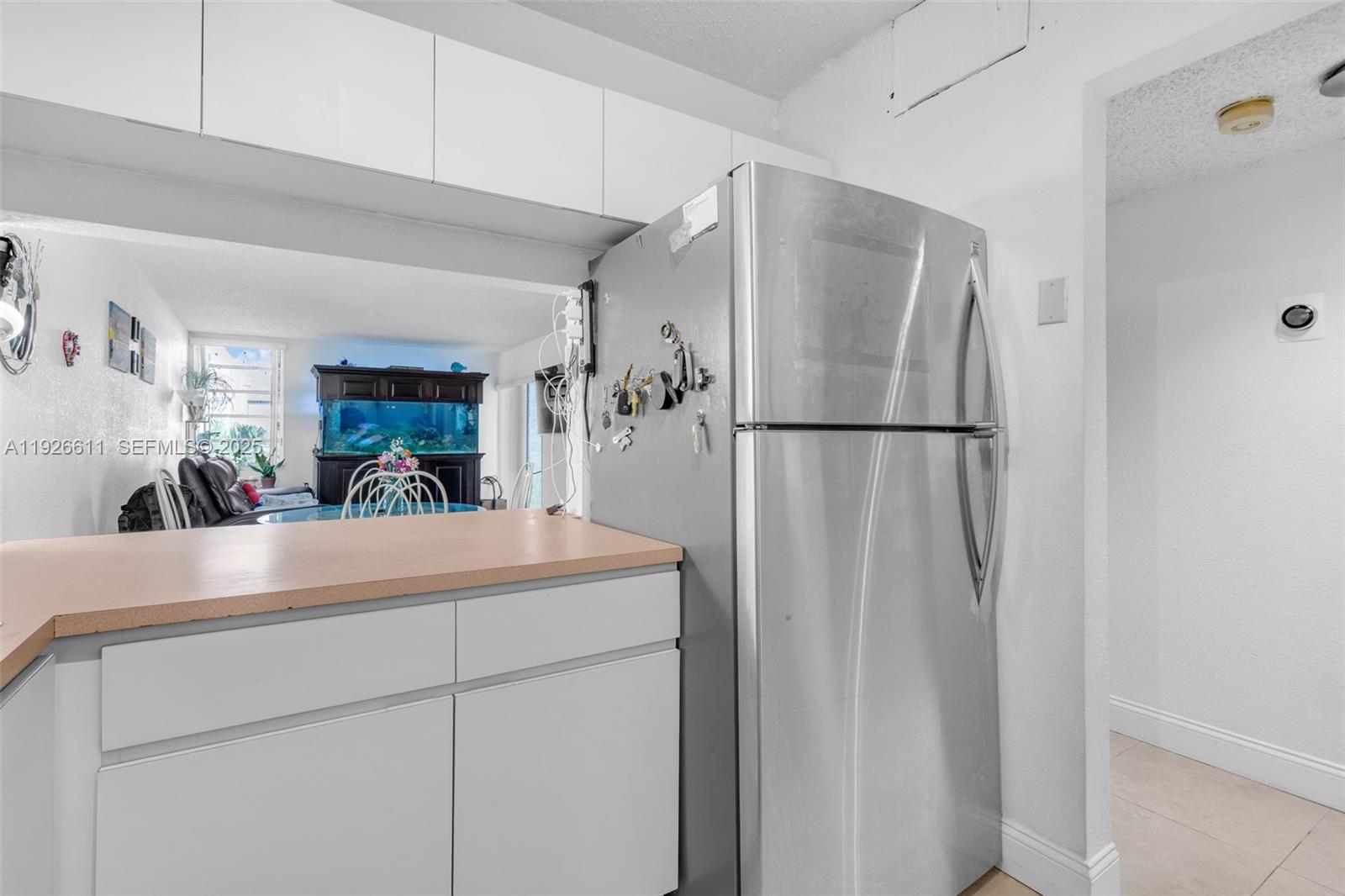 1900 West 68th Street, Unit F302 Hialeah, FL 33014 - Photo 10 of 34 a kitchen with a refrigerator and a sink