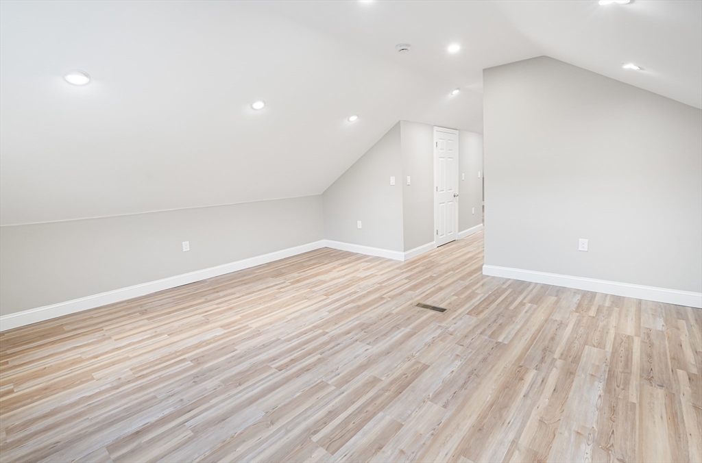 98 Southville Road, Unit B Southborough, MA 01772 - Photo 21 of 32 a view of an empty room with wooden floor and a window