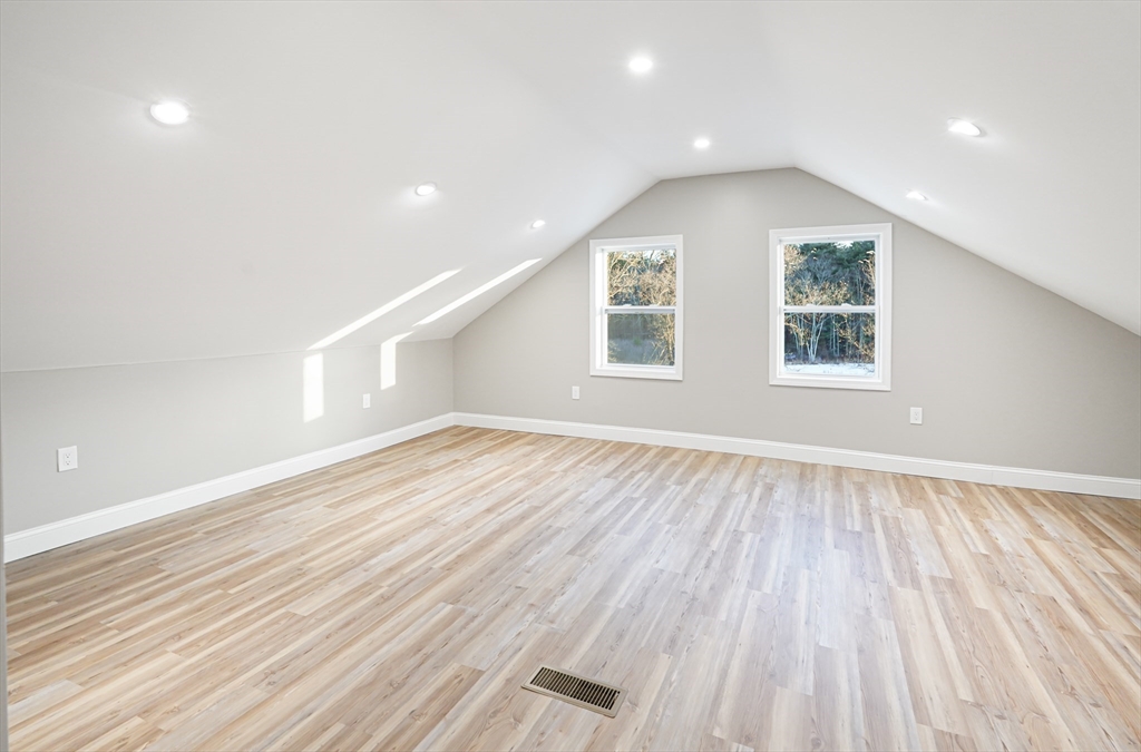 98 Southville Road, Unit B Southborough, MA 01772 - Photo 22 of 32 an empty room with wooden floor and windows