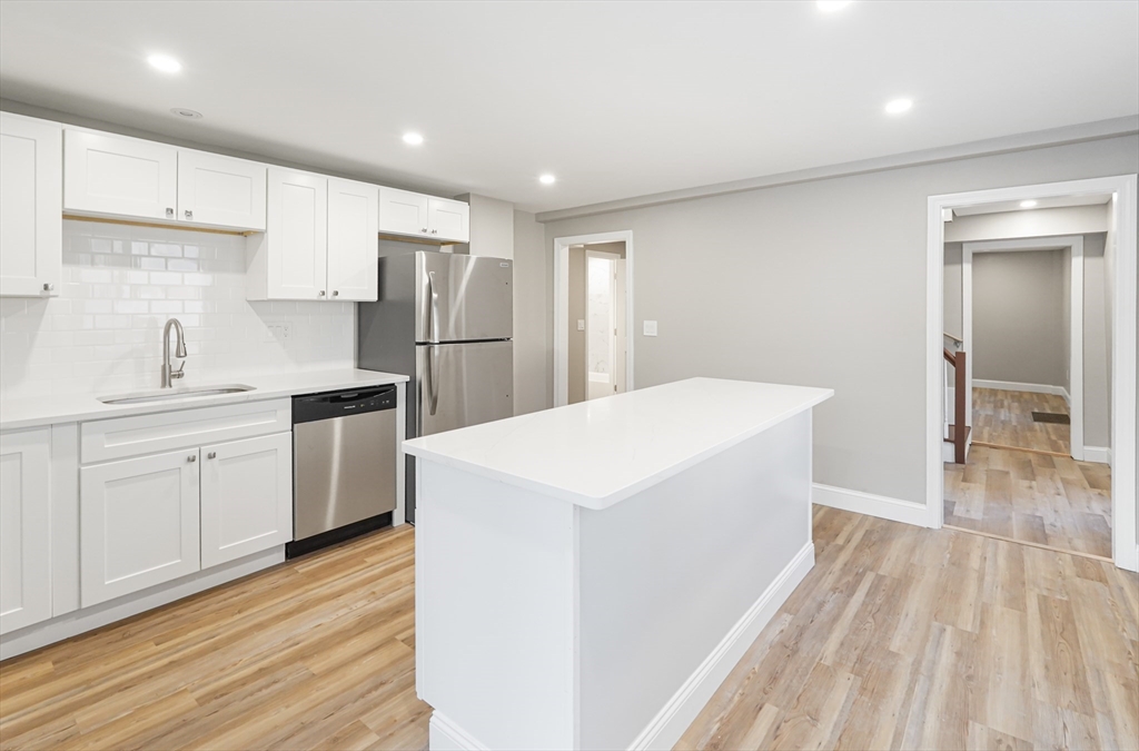 98 Southville Road, Unit B Southborough, MA 01772 - Photo 4 of 32 a kitchen with a sink a refrigerator and white cabinets