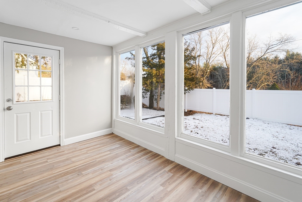 98 Southville Road, Unit B Southborough, MA 01772 - Photo 6 of 32 a view of a large window with wooden floor