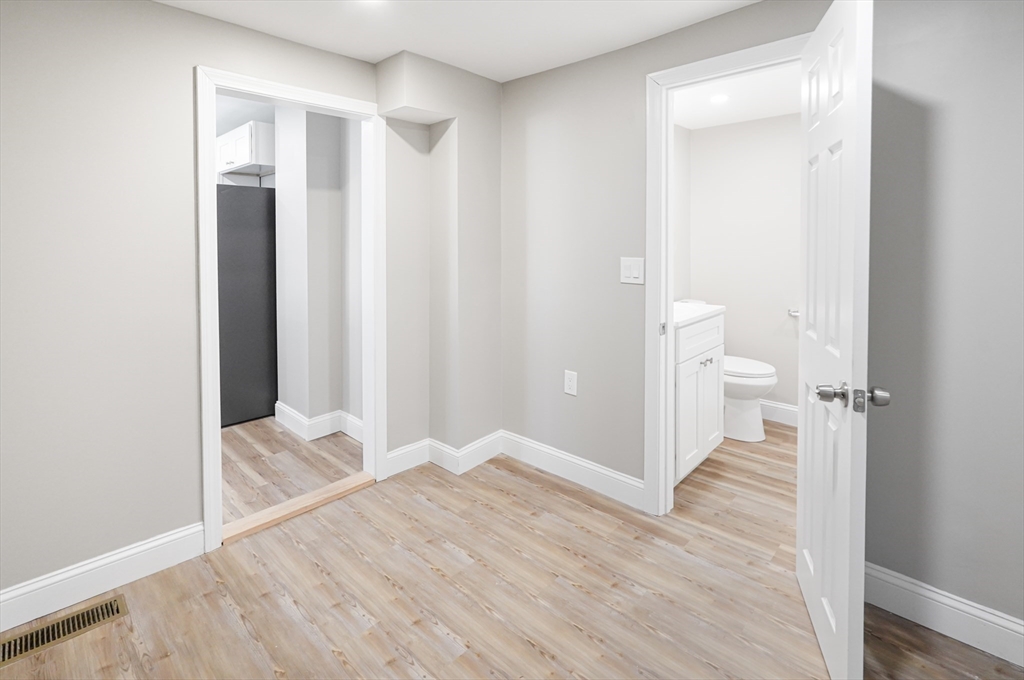 98 Southville Road, Unit B Southborough, MA 01772 - Photo 8 of 32 a view of empty room with wooden floor