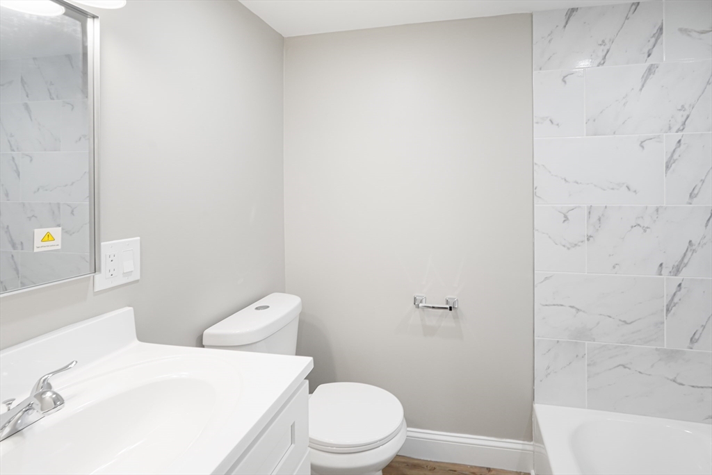 98 Southville Road, Unit B Southborough, MA 01772 - Photo 9 of 32 a white toilet sitting next to a bath tub