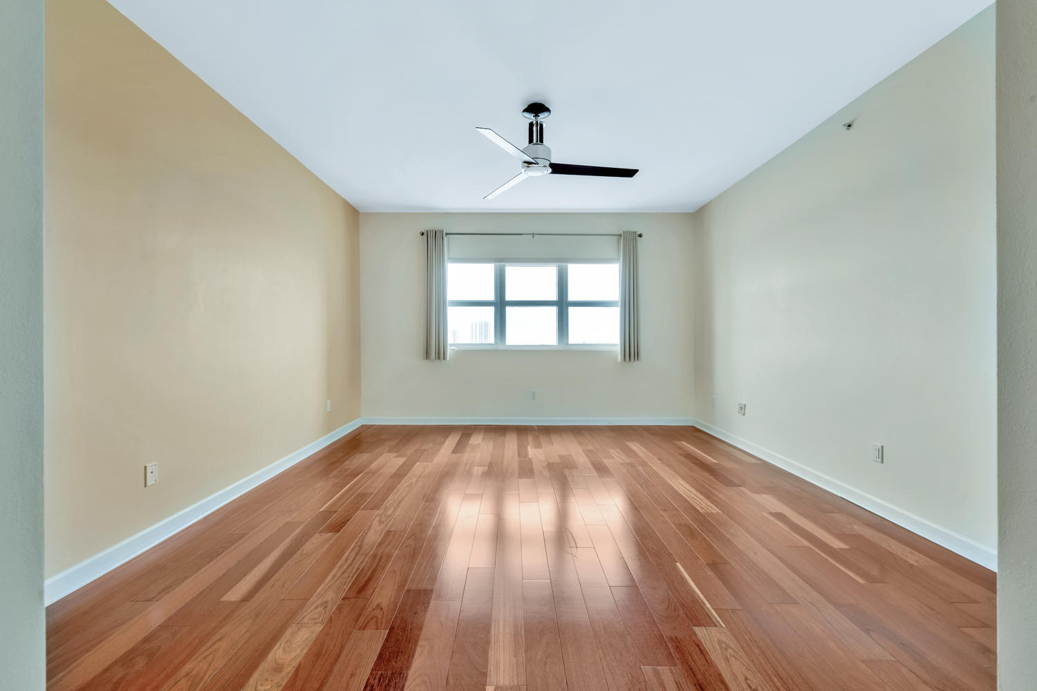 2640 Lake Shore Drive, Unit 1011 Riviera Beach, FL 33404 - Photo 12 of 60 a view of empty room with wooden floor and fan
