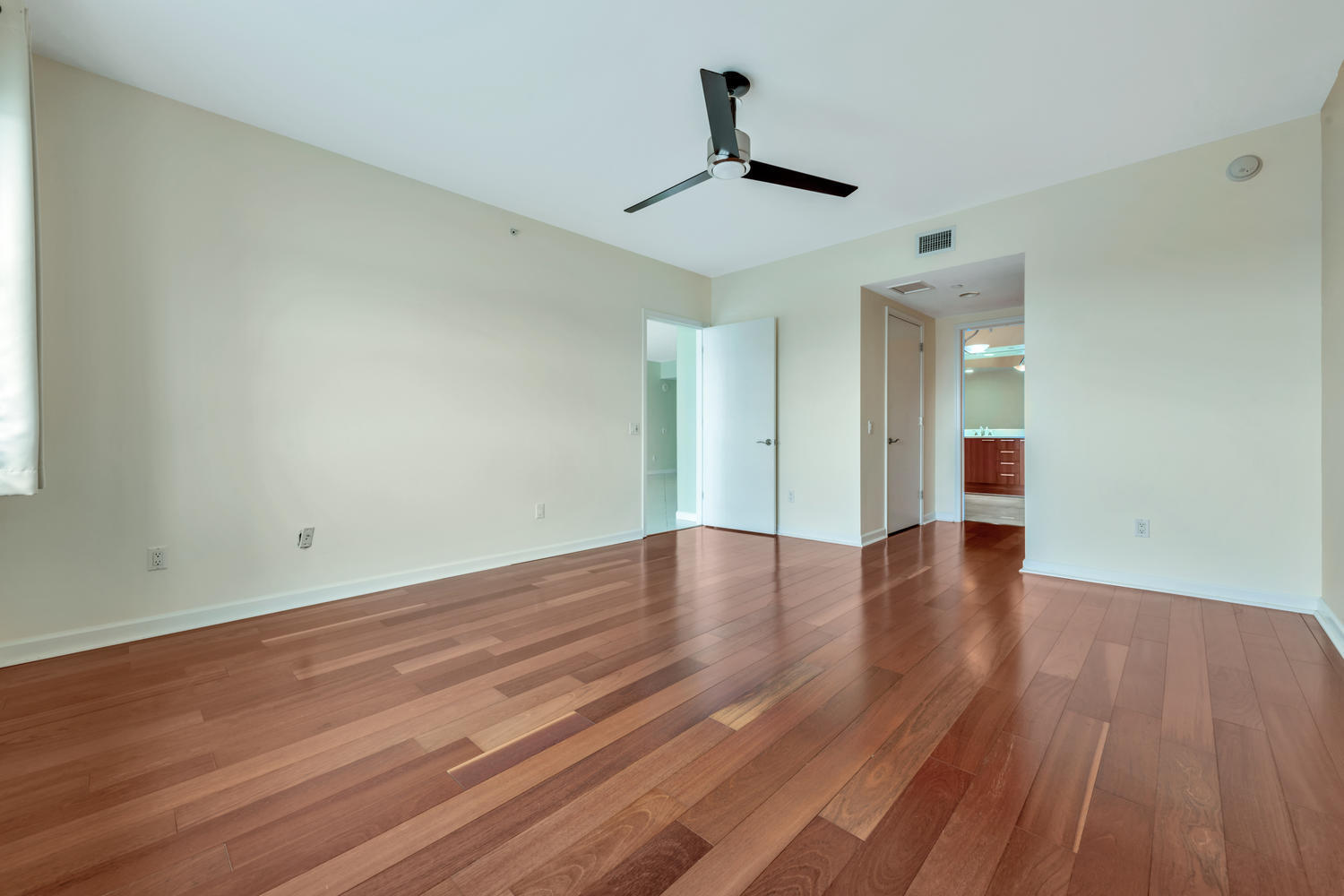 2640 Lake Shore Drive, Unit 1011 Riviera Beach, FL 33404 - Photo 14 of 60 a view of a room with wooden floor and ceiling fan