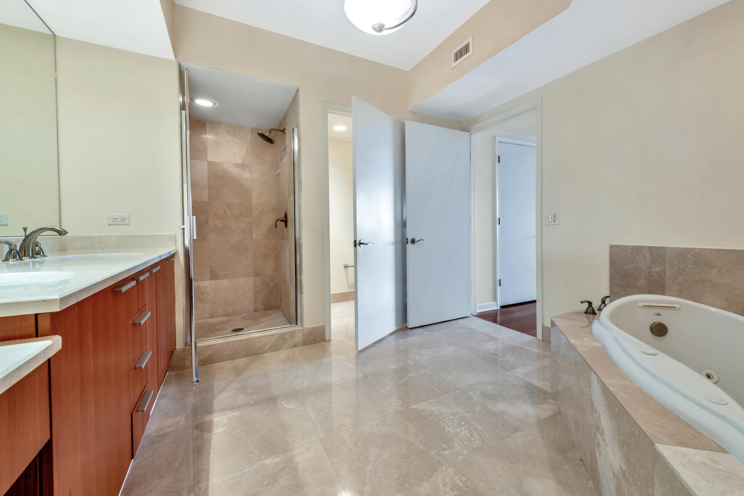 2640 Lake Shore Drive, Unit 1011 Riviera Beach, FL 33404 - Photo 16 of 60 a bathroom with a tub sink shower and mirror