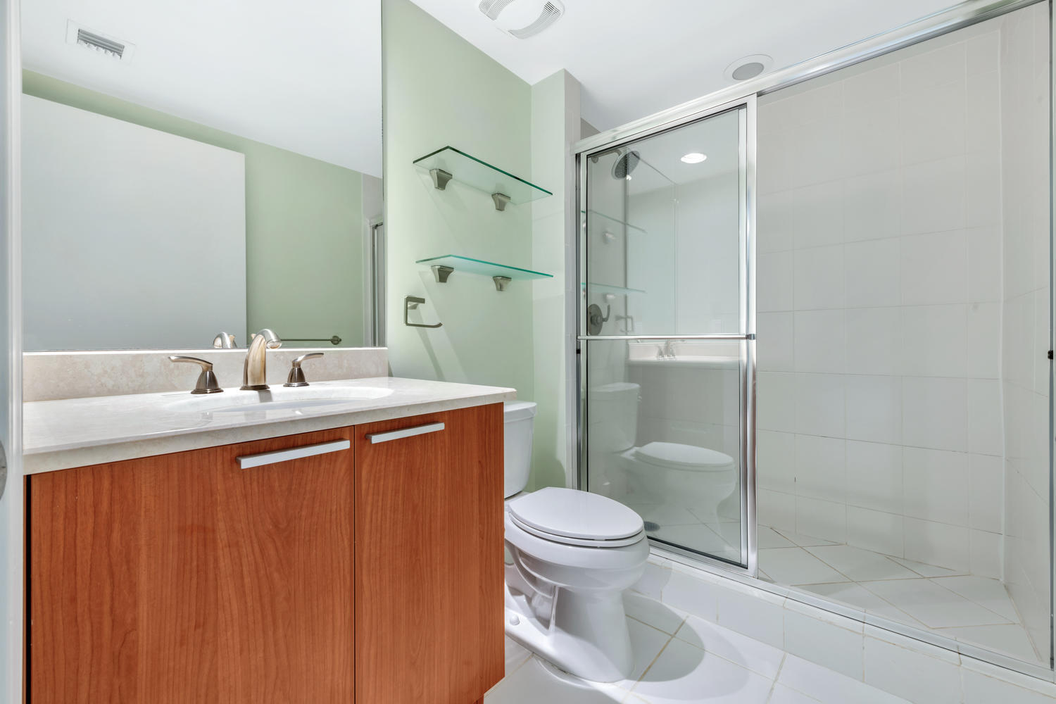 2640 Lake Shore Drive, Unit 1011 Riviera Beach, FL 33404 - Photo 20 of 60 a bathroom with a granite countertop sink toilet and shower