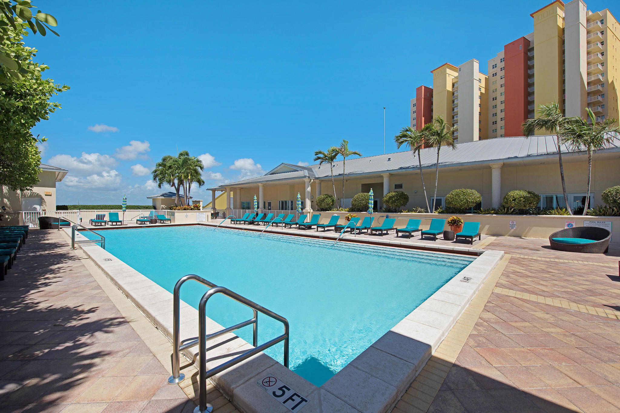 2640 Lake Shore Drive, Unit 1011 Riviera Beach, FL 33404 - Photo 36 of 60 a view of swimming pool with outdoor seating and a garden