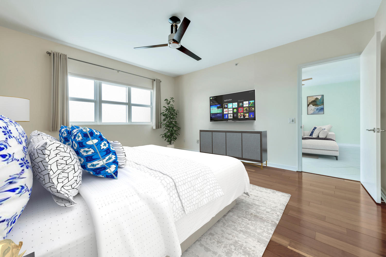 2640 Lake Shore Drive, Unit 1011 Riviera Beach, FL 33404 - Photo 4 of 60 a bedroom with a bed and wooden floor
